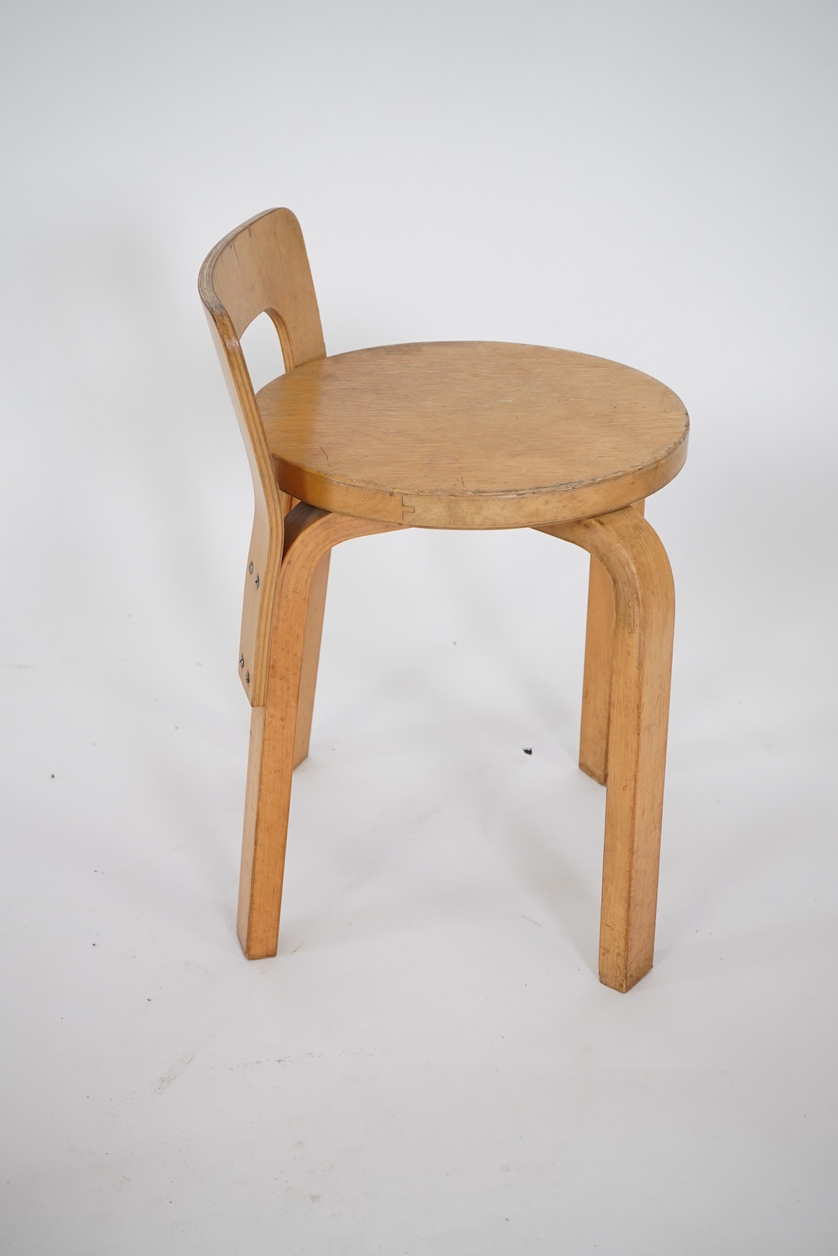 Alvar Aalto (Finnish 1898-1976) for Artek, distributed by Finmar: A pair of 'Model 60' stools and a similar 'K65' stool